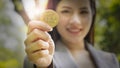 Bitcoins - Bitcoin in hand of a casual businesswoman to show the