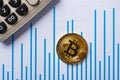 Bitcoins and caculator on a chart as financial conceptbitcoins and caculator on a chart Royalty Free Stock Photo