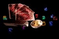 Bitcoins, cards, dices on black background. Cryptocurrencie gambling concept