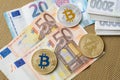 Bitcoins close-up on euro currency background. Royalty Free Stock Photo