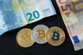 Bitcoins close-up on euro currency background. Royalty Free Stock Photo