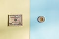 Bitcoins and dollars on a pastel background, the concept of choice between cryptocurrency and paper money Royalty Free Stock Photo