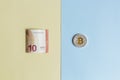 Bitcoins and EURO on a pastel background, the concept of choice between cryptocurrency and paper money Royalty Free Stock Photo