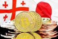 Bitcoins on Georgia and Japan flag background