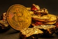 Bitcoins and gold nuggets on table Royalty Free Stock Photo
