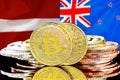 Bitcoins on Latvia and New Zealand flag background