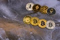 Bitcoins, litecoins and ethereum lie on blue abstract background