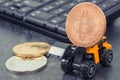 Bitcoins, miniature excavator and computer keyboard. Cryptocurrency and international network payment. Finance concept Royalty Free Stock Photo