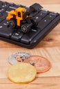 Bitcoins and miniature excavator on computer keyboard, symbol of electronic virtual money and mining cryptocurrency Royalty Free Stock Photo