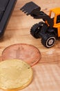 Bitcoins, miniature excavator and computer keyboard, symbol of electronic virtual money and mining cryptocurrency Royalty Free Stock Photo