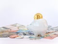 Bitcoins, New Virtual Money concept in piggy bank. Gold bitcoins with name Safety dollars` euros` background. Golden coins with