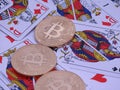 Bitcoins and open deck of cards. Royalty Free Stock Photo