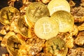 Bitcoins and pieces of gold closeup. Bitcoin against gold, what is the more attractive asset