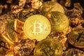 Bitcoins and pieces of gold closeup. Bitcoin against gold, what is the more attractive asset