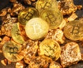 Bitcoins and pieces of gold closeup. Bitcoin against gold, what is the more attractive asset