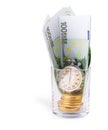 Bitcoins on a pile of one hundred euros and a bulb clock on empy glass. Royalty Free Stock Photo