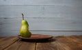 A bite pear on a plate on wooden background Royalty Free Stock Photo