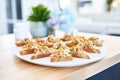 bite-sized almond butter toast triangles on a platter for catering