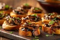 Bite-sized shiitake mushroom crostini topped with a drizzle of balsamic glaze, representing an elegant and flavorful appetizer