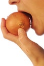 Biting into an onion Royalty Free Stock Photo