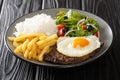 Bitoque is a beloved Portuguese dish that includes lean steak accompanied by rice and french fries topped with a fried egg closeup Royalty Free Stock Photo