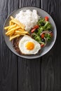 Bitoque is a classic Portuguese dish that is simply a steak drizzled with a butter pan sauce and topped with a fried egg closeup Royalty Free Stock Photo