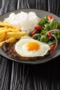 Bitoque is a classic Portuguese dish that is simply a steak drizzled with a butter pan sauce and topped with a fried egg closeup Royalty Free Stock Photo