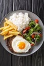 Bitoque is a traditional Portuguese dish, which consists of grilled beef steak with fries, rice, various salads and topped with an Royalty Free Stock Photo
