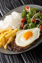 Bitoque is a traditional Portuguese dish, which consists of grilled beef steak with fries, rice, various salads and topped with an Royalty Free Stock Photo