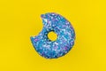 Bitten blue glazed donut with colorful sprinkles Royalty Free Stock Photo