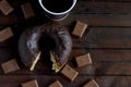Bitten chocolate donut with coffee and milk chocolate. Royalty Free Stock Photo