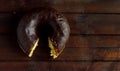 Bitten chocolate donut on wooden background. Royalty Free Stock Photo