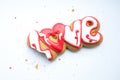 A bitten cookie for Valentine`s day or for a wedding day and crumbs on a white background. Royalty Free Stock Photo