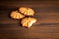 Bitten cookie on a wooden texture table. Sweets and unhealthy diet Royalty Free Stock Photo