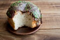 Bitten donut with chocolate on a wooden background