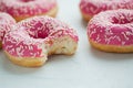 Bitten donut. Sweet icing sugar food. Dessert colorful snack. Glazed sprinkles. Treat from delicious pastry breakfast. Bakery cake Royalty Free Stock Photo