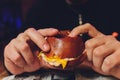 A bitten fresh burger in the hands of a man. Royalty Free Stock Photo