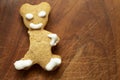 bitten gingerbread bear , on a wood chopping board texture Royalty Free Stock Photo