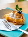 Lemon meringe cheese tart on blue dish