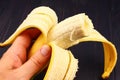 Bitten off banana in hand closeup Royalty Free Stock Photo