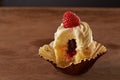 Bitten raspberry filled cupcake on wooden table Royalty Free Stock Photo