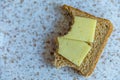 Bitten rye bread and cheese sandwich closeup view Royalty Free Stock Photo