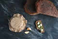 Bitten sandwich of piece bread with onion chives and cloves garlic, sourdough in jar and loaf rye bread, top view Royalty Free Stock Photo