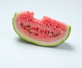 Bitten slice of watermelon on a white background. Royalty Free Stock Photo