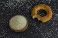 Bitten Turkish Bagel,Simit on the black surface with uncooked sesame seeds