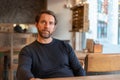 Bitter and disillusioned middle aged caucasian male sitting at the table in coffee shop Royalty Free Stock Photo