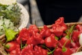 Bitter hot red peppers of different varieties of the farmer in a basket lie in the window of the farmer`s market. The latest Royalty Free Stock Photo