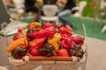 Bitter hot red peppers of different varieties of the farmer in a basket lie in the window of the farmer`s market. The latest Royalty Free Stock Photo