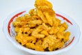 Savory and delicious bitter melon chips in a bowl on a white background. Royalty Free Stock Photo