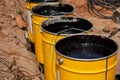 Bitumen mastic in buckets. Protective bitumen mastic for concrete pavement. Material for waterproofing the foundation